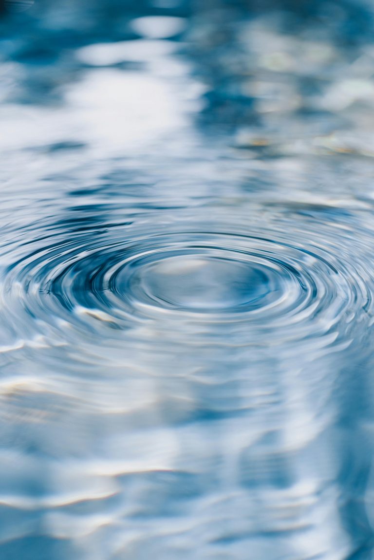 Serene ripples on clear blue water, capturing tranquility and purity.